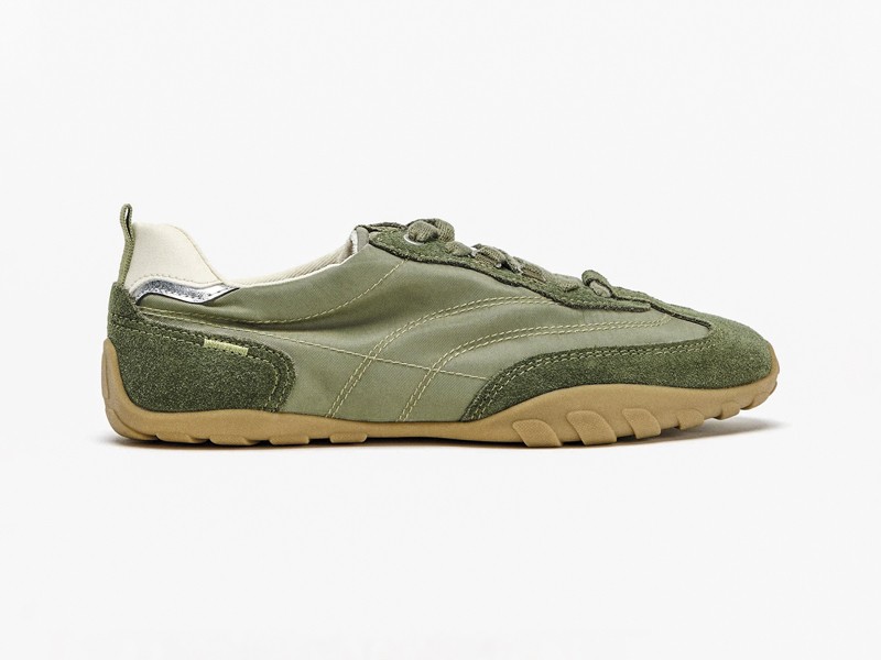 Olive-toned urban sneakers with suede cues and gum sole units