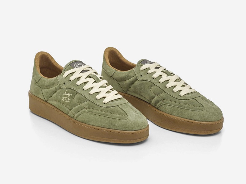 Olive-toned urban sneakers with suede cues and gum sole units