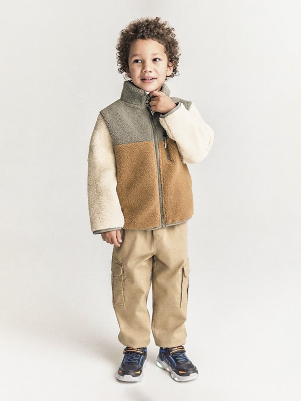 Kids outdoor footwear with traction soles and protective reinforcements